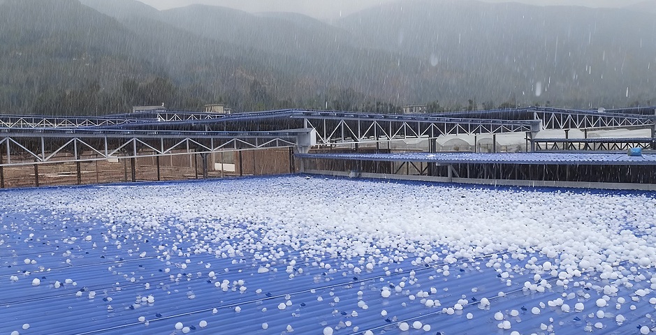 1 Hail covering the roof with mountains in the rainy background