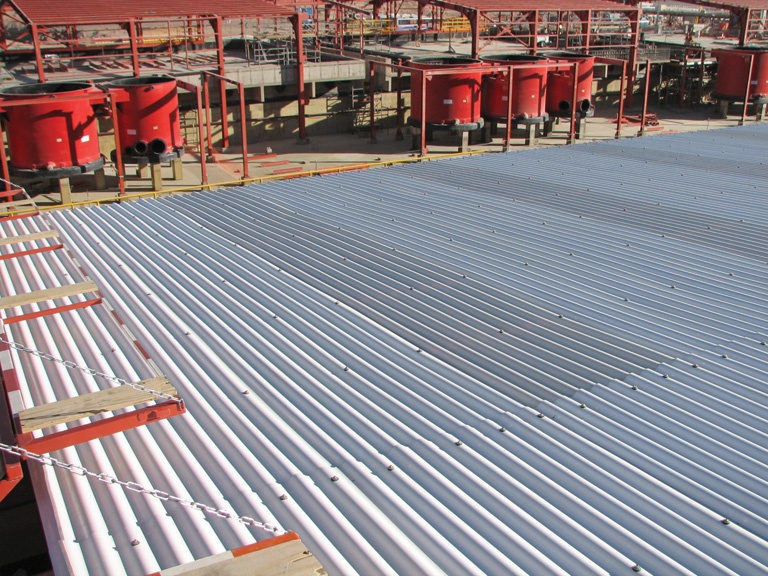 1 industrial site with metal roof and red tanks
